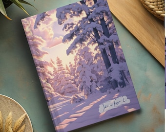 May include: A purple and white notebook with a snowy forest scene and a sunset in the background. The notebook has the name "Jennifer L" written on it. The notebook is on a light blue surface.