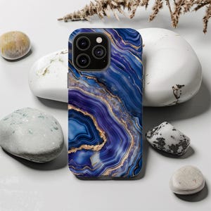 May include: A blue and purple phone case with a marble pattern and gold accents. The case has a camera cutout and is designed for a smartphone.