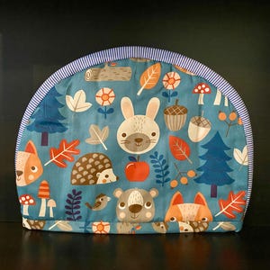 Teapot Cosy. Cartoon-style forrest. Blue.