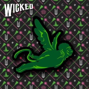 May include: Green winged monkey with a black outline, flying against a black background with a repeating pattern of pink and green broomsticks and stars.
