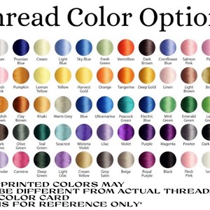May include: A color chart displaying thread color options, with a variety of shades from white to black. The chart includes color names like "Sky Blue," "Vermillion," and "Magenta." Text at the bottom states, "Printed colors may be different from actual thread."