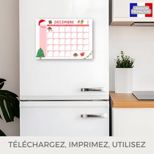 Puede incluir: Un calendario de diciembre con fondo rosa, con ilustraciones navide&ntilde;as. El calendario est&aacute; pegado a un frigor&iacute;fico blanco. El texto &laquo;&nbsp;Notas&nbsp;&raquo; es visible, as&iacute; como el texto franc&eacute;s &laquo;&nbsp;VERSION FRANCAISE&nbsp;&raquo;.