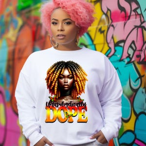 May include: White sweatshirt featuring a graphic of a woman with yellow and black hair, a black choker, and butterflies. The text "Unapologetically DOPE" is printed in orange and yellow. The background is a colorful graffiti wall.
