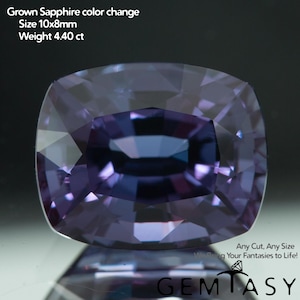 May include: A cushion-cut color-change lab-grown sapphire with a purple and blue hue. Text reads: Grown Sapphire color change, Size 10x8mm, Weight 4.40 ct, Any Cut, Any Size We Bring Your Fantasies to Life!, GEMTASY with a diamond icon.