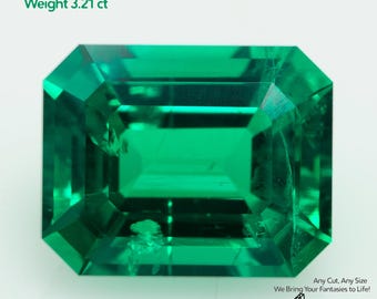 May include: A vibrant, rectangular-cut, emerald-green gemstone. The image includes text indicating it's a grown Colombian emerald, measuring 10x8mm and weighing 3.21 carats. The gem is set against a white background.