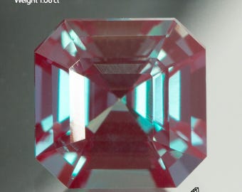 May include: Lab-grown Alexandrite gemstone, 6x6mm in size, weighing 1.06 ct. The gem has a rectangular shape with a faceted cut, displaying a mix of red and teal colors. The image also includes the Gemtasy logo.