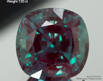 May include: A lab-grown alexandrite gemstone with a cushion cut. The gem is a mix of teal and deep purple hues, with dimensions of 11x11mm and a weight of 7.30 carats. The image includes the text "Alexandrite lab-grown" and "GEMTASY".
