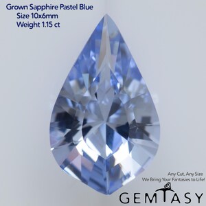 May include: A pear-shaped, pastel blue sapphire gemstone. The gem is 10x6mm and weighs 1.15 ct. The image includes the text "Grown Sapphire Pastel Blue", "Size 10x6mm", and "Weight 1.15 ct". The gem is faceted and reflects light.