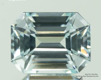 May include: A faceted, rectangular Yttrium Aluminum Garnet gemstone, measuring 8x6mm and weighing 2.73 ct. The gem is clear with multiple facets, reflecting light. Text on the image reads "Yttrium Aluminum Garnet", "Size 8x6mm", "Weight 2.73 ct", and "GEMTASY".