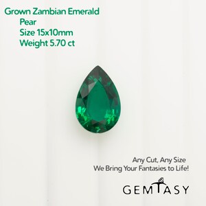 May include: A pear-shaped, green Zambian emerald gemstone weighing 5.70 carats. The stone measures 15mm by 10mm.  The text "Grown Zambian Emerald Pear Size 15x10mm Weight 5.70 ct Any Cut, Any Size We Bring Your Fantasies to Life! GEMTASY" is visible in the image.