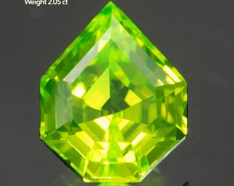 May include: A faceted, bright green Lutetium Aluminum Garnet gemstone. The gem is cut into a unique shape with multiple facets, reflecting light. The text on the image reads: Lutetium Aluminum Garnet, Size 7.5x6mm, Weight 2.05 ct. The logo for Gemtasy is in the bottom right corner.