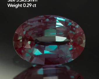 May include: An oval-cut, lab-grown alexandrite gemstone. The gem is a mix of purple and teal colors, with a size of 5.5x3.5mm and a weight of 0.29 ct. The gem is displayed against a dark background, with the text "Alexandrite lab-grown Size 5.5x3.5mm Weight 0.29 ct".