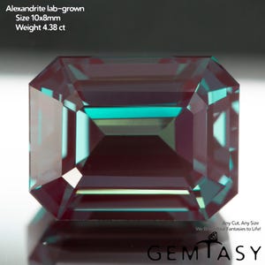 May include: A lab-grown alexandrite gemstone with an emerald cut, displaying a color-shifting teal and deep purple hue. The text reads: Alexandrite lab-grown, Size 10x8mm, Weight 4.38 ct, Any Cut, Any Size, We Bring Your Fantasies to Life!, GEMTASY.