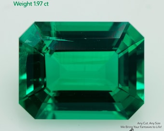 May include: A vibrant, emerald-cut, grown Colombian emerald gemstone. The gem is a deep green color and measures 9x7mm, weighing 1.97 ct. The image includes the text "Grown Colombian Emerald", "Size 9x7mm", and "Weight 1.97 ct".