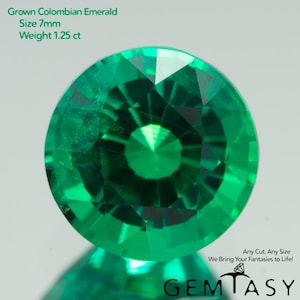 May include: A vibrant, round, faceted emerald gemstone. The image includes text indicating it is a 7mm grown Colombian emerald, weighing 1.25 ct. The gem is a brilliant green color, with multiple facets reflecting light. The image also includes the text "GEMTASY".
