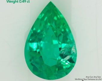 May include: A pear-shaped, vibrant green emerald gemstone. The text in the image reads "Grown Colombian Emerald, Size 7x4.5mm, Weight 0.49 ct." The gemstone is set against a white background. The logo for Gemtasy is in the bottom right corner.