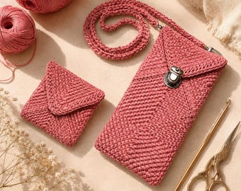 May include: A dusty rose crochet crossbody phone pouch with a metal clasp closure and a matching crochet coin purse. The set includes two balls of dusty rose yarn, a gold-toned crochet hook, and a pair of ornate gold-toned metal scissors.