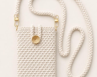 May include: A cream-colored crocheted crossbody phone pouch featuring a textured stitch pattern, a single gold-toned circular button closure, and a matching thick braided cord strap attached with gold-toned metal lobster claw clasps.