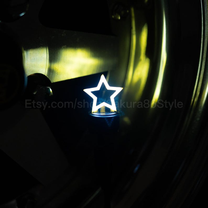 May include: A bright white star-shaped light. The star is illuminated with a bright white light, set against a dark background. The Etsy shop name is visible in the image.