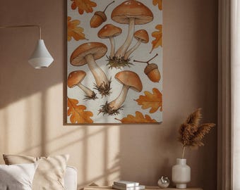 Op de afbeelding: Een canvas print met een aquarel illustratie van paddenstoelen, eikels en eikenbladeren in bruin- en oranjetinten. Het kunstwerk heeft een neutrale achtergrond en wordt aan een muur getoond.