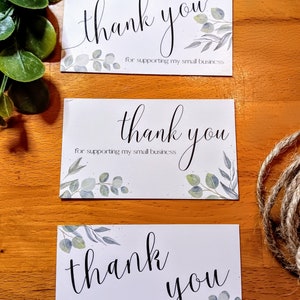 May include: Three white cards with the text "thank you" in black cursive writing and the words "for supporting my small business" printed below. Each card has a watercolor design of green leaves.