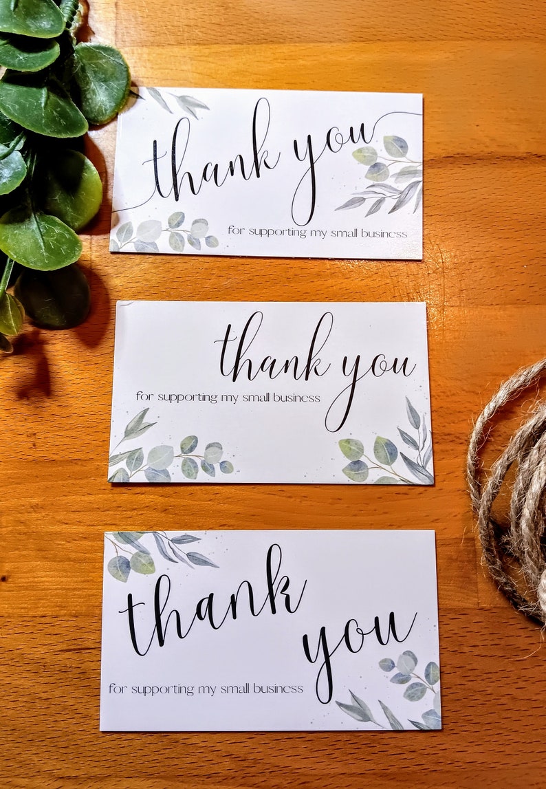 May include: Three white cards with the text "thank you" in black cursive writing and the words "for supporting my small business" printed below. Each card has a watercolor design of green leaves.