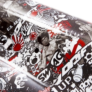 May include: A roll of black and white sticker paper featuring a collage of graphics and text. The design includes images of Bruce Lee, skulls, and various logos, with red accents. The words "JDM", "DRIFT", and "BOMB" are visible.