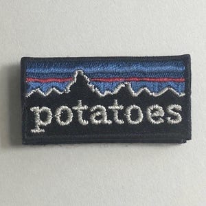 May include: A white ceramic mug with a black handle and the text "But First, Coffee" in a handwritten style. The mug is on a white surface. The mug is 4 inches tall.