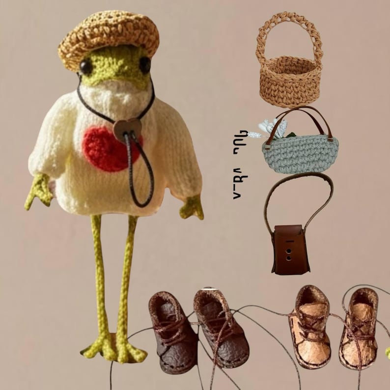 May include: A crocheted green frog doll wearing a white sweater with a red heart, a tan hat, and a black cord necklace. Accessories include a tan woven basket, a light blue crocheted bag, a brown leather-like bag, and two pairs of small shoes.
