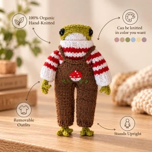 May include: A hand-knitted frog doll featuring a white and red striped sweater and brown overalls with a small embroidered mushroom. The doll has black eyes, green limbs, and stands upright. Text includes 100% Organic Hand-Knitted, Can be knitted in color you want, Removable Outfits, and Stands Upright.