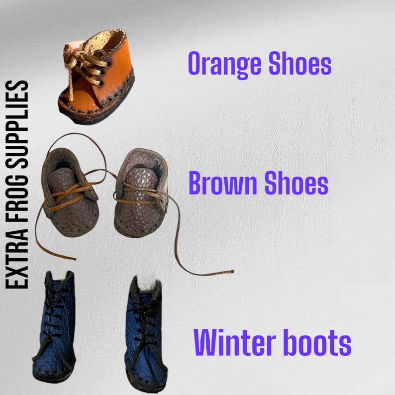 May include: A collection of miniature footwear labeled EXTRA FROG SUPPLIES including one orange shoe, a pair of brown shoes, and a pair of blue winter boots. Each item features laces and distinct textures, presented with text labels for each style.