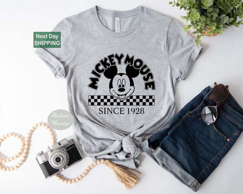 a mickey mouse shirt with a camera next to it