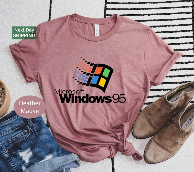 a pink t - shirt with the microsoft 95 logo on it