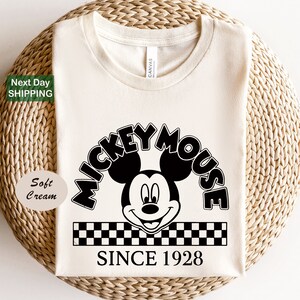 a mickey mouse shirt sitting on top of a wicker basket