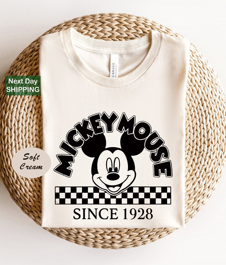 a mickey mouse shirt sitting on top of a wicker basket