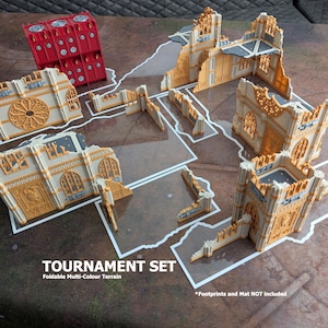 May include: A tournament set of foldable multi-colour terrain pieces featuring various ruined gothic-style building walls in tan and cream, along with a single red rectangular structure with circular details. Text reads: TOURNAMENT SET Foldable Multi-Colour Terrain.