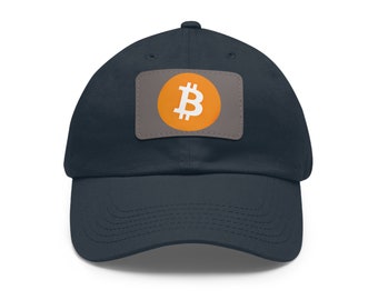 May include: A navy blue baseball cap with a Bitcoin logo patch. The patch features an orange circle with a white Bitcoin symbol on a gray background. The cap is made of a soft material and has a curved brim.