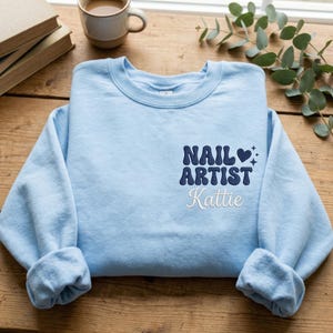 May include: A set of three ceramic mugs with a speckled, matte finish. The mugs are in shades of cream, light gray, and dark gray. Each mug has a simple, minimalist design, perfect for coffee or tea.