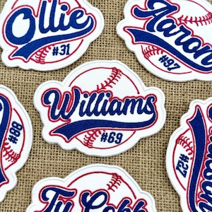 May include: Embroidered baseball patches with names and numbers. Each patch has a white background with a baseball design, red stitching, and blue lettering. Names such as "Ollie" and "Williams" are displayed.
