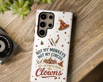 May include: White phone case with a circus theme. The case features the text "NOT MY MONKEYS NOT MY CIRCUS BUT I DEFINITELY KNOW THE CLOWNS" in a playful font, along with illustrations of circus tents, stars, and juggling pins.