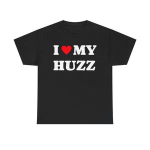 May include: Black t-shirt with the text "I ♥ MY HUZZ" in white block letters. The heart symbol is red. The shirt is a casual wear item.