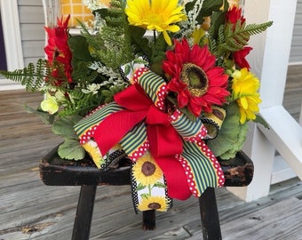 Spring flowers on a black distressed bench with beautiful sunflowers