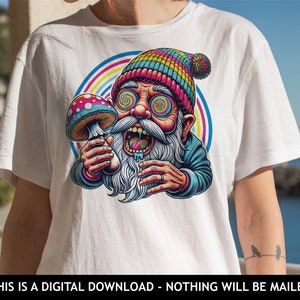 May include: White t-shirt featuring a colorful cartoon illustration of a psychedelic gnome holding a mushroom. The gnome has swirling eyes and a rainbow-colored hat. The text at the bottom reads: THIS IS A DIGITAL DOWNLOAD - NOTHING WILL BE MAILED.