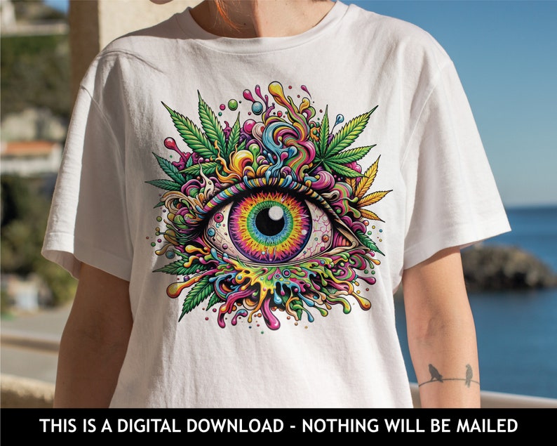 May include: A white t-shirt with a colorful psychedelic eye graphic. The eye is surrounded by green leaves and colorful swirls. The graphic is a digital illustration.