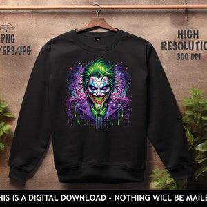 May include: Black sweatshirt featuring a colourful graphic of the Joker, a character from the Batman comics. The Joker is depicted with green hair, a purple suit, and a green and purple background.