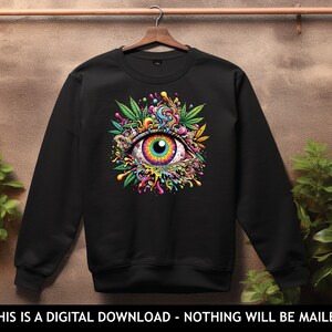May include: Black sweatshirt with a colorful psychedelic eye graphic. The eye is surrounded by green leaves and colorful swirls.