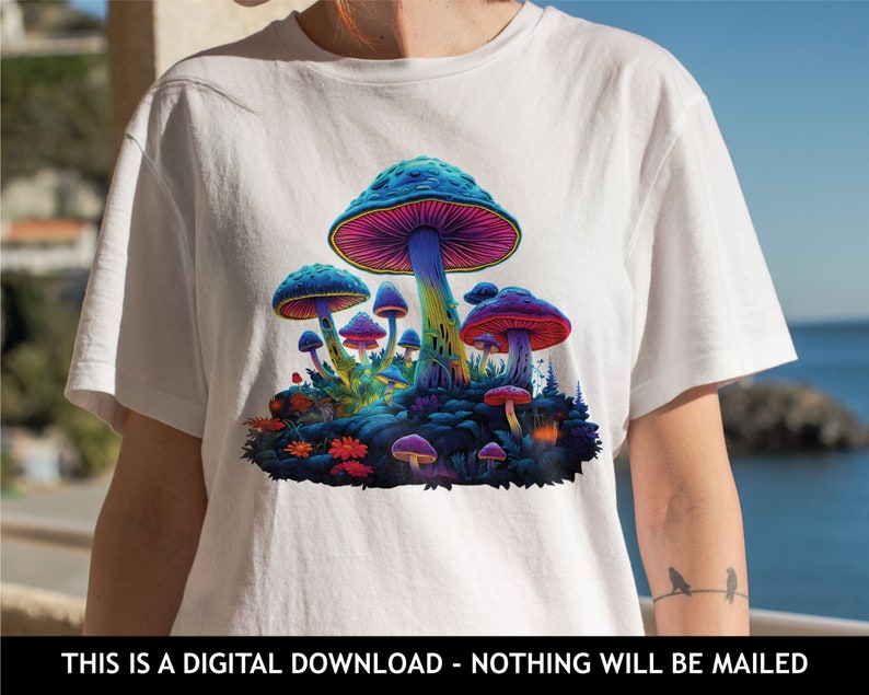 May include: A white t-shirt with a colorful psychedelic mushroom graphic. The mushrooms are in various shades of blue, purple, and pink. The graphic is centered on the shirt.