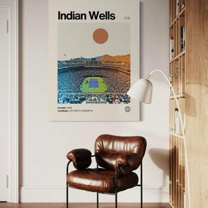 May include: A minimalist poster with a white background featuring a graphic of a stadium with a tennis court in the center. The text "Indian Wells /CA" is at the top of the poster. The text "Founded/2000" and "Coordinates/33.7239&deg;N, 116.3059&deg;W" is at the bottom of the poster.