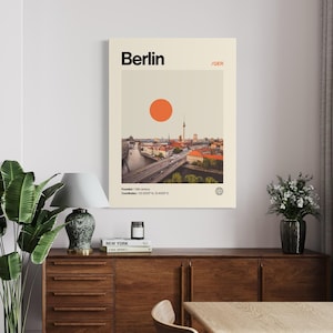 Puede incluir: Un p&oacute;ster enmarcado con una ilustraci&oacute;n de Berl&iacute;n de estilo vintage. La impresi&oacute;n incluye el nombre de la ciudad en negro, un c&iacute;rculo naranja y un paisaje urbano. El texto incluye el a&ntilde;o de fundaci&oacute;n y las coordenadas.