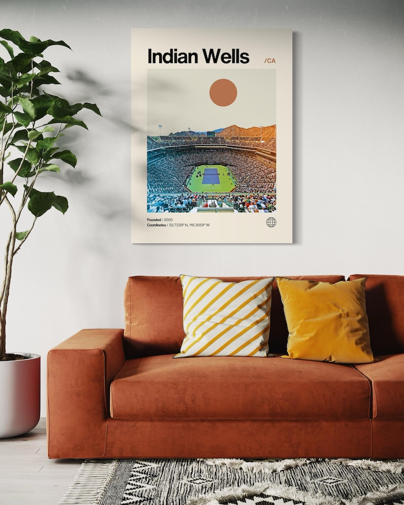 May include: A retro-style poster with a minimalist design featuring a photograph of a large stadium with a tennis court in the center. The poster is titled "Indian Wells / CA" and includes the text "Founded / 2009" and "Coordinates: 33.7205&deg;N, 116.3059&deg;W".